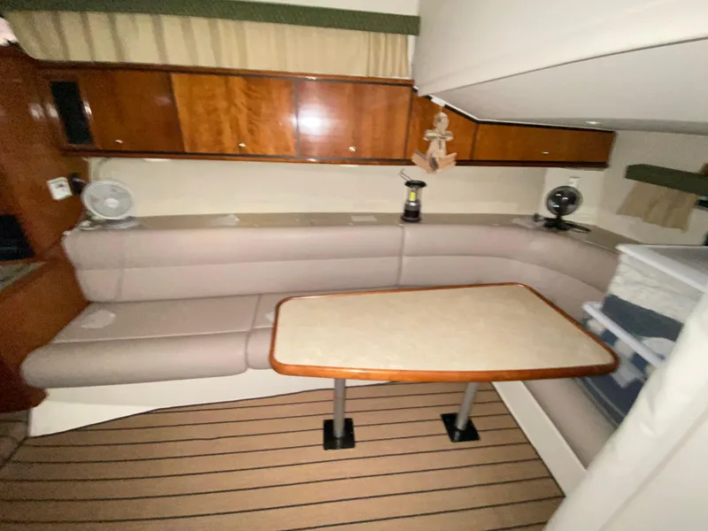Slide: The Image of Interior of 1999 Trojan 320 Express yacht with seating and table. - 11