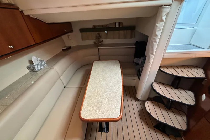 Slide: The Image of Interior of 1999 Trojan 320 Express yacht with seating area and wooden steps. - 24