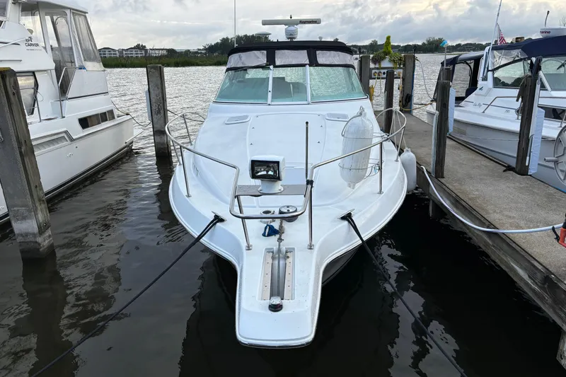 Slide: The Image of 1999 Trojan 320 Express boat docked at marina, front view. - 4