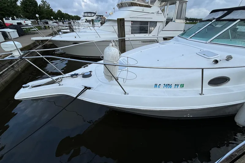 Slide: The Image of 1999 Trojan 320 Express yacht docked at marina, side view. - 5