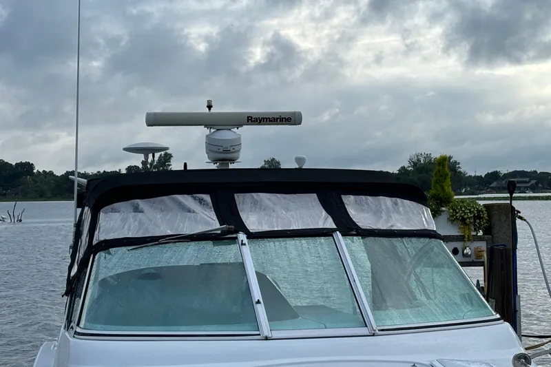 Slide: The Image of 1999 Trojan 320 Express boat with Raymarine radar, docked on a cloudy day. - 6