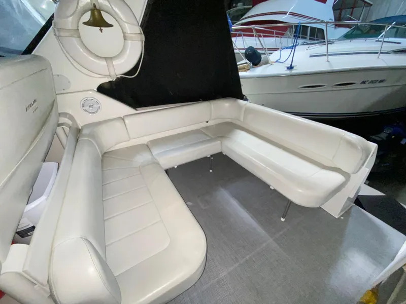 Slide: The Image of 1999 Trojan 320 Express boat interior with white leather seating and nautical decor. - 7