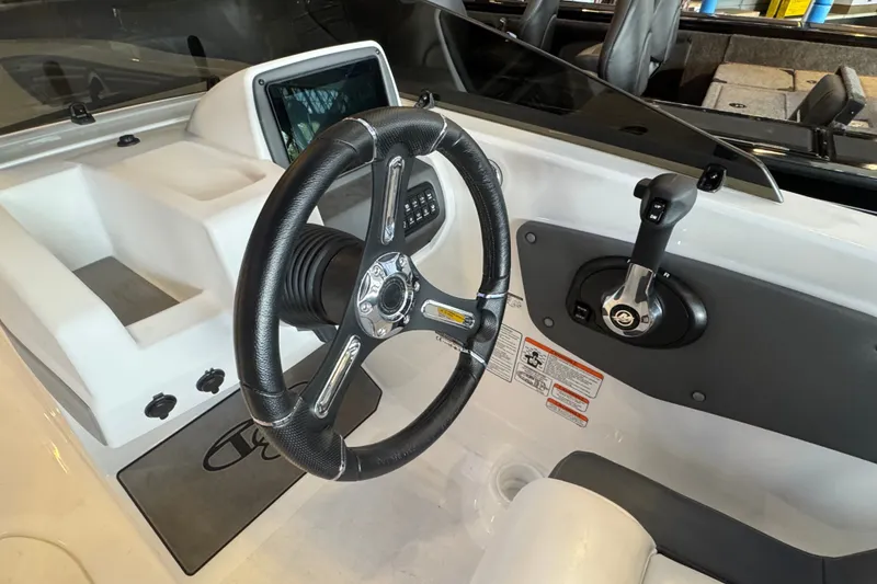 Slide: The Image of Steering wheel and controls of 2026 Tahoe T21 boat interior. - 9