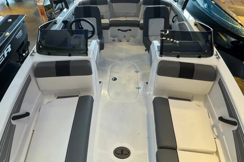 Slide: The Image of 2026 Tahoe T21 boat interior with gray seating and dual consoles. - 7