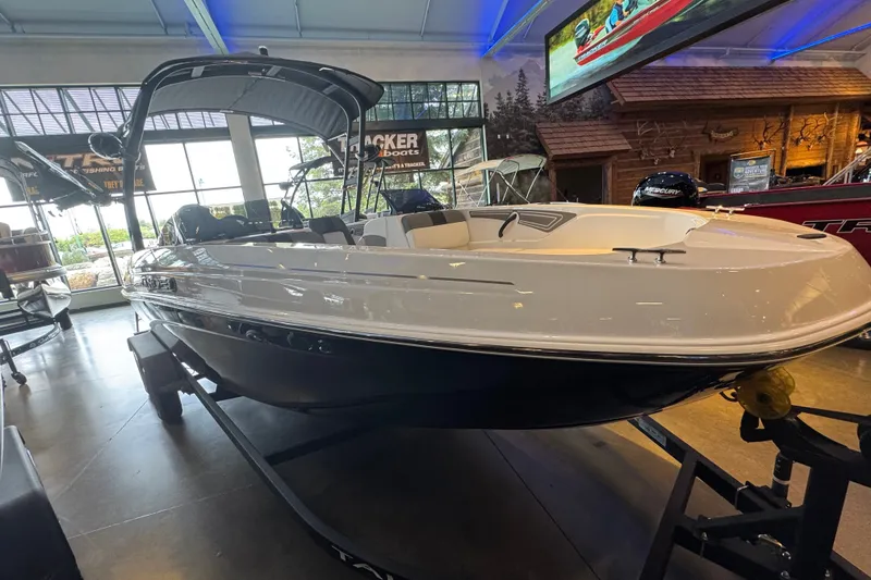 Slide: The Image of 2026 Tahoe T21 boat displayed indoors, showcasing sleek design and modern features. - 2