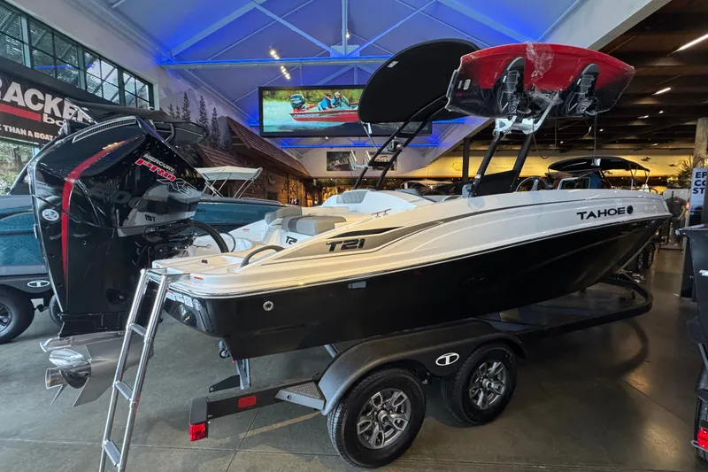 Slide: The Image of 2026 Tahoe T21 boat displayed indoors, featuring sleek design and powerful engine. - 3