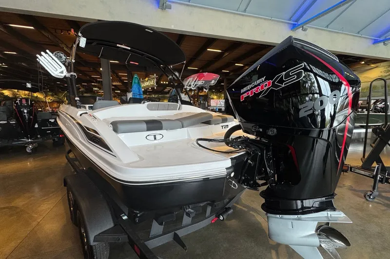 Slide: The Image of 2026 Tahoe T21 boat with Mercury Pro XS 200 engine displayed indoors. - 4