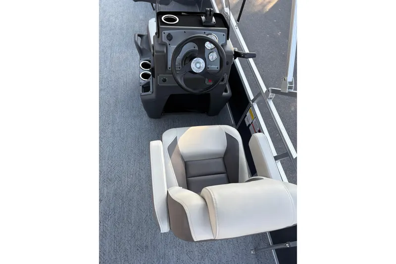 Slide: The Image of 2026 Sun Tracker Bass Buggy 18 DLX interior with steering console and comfortable seating. - 14