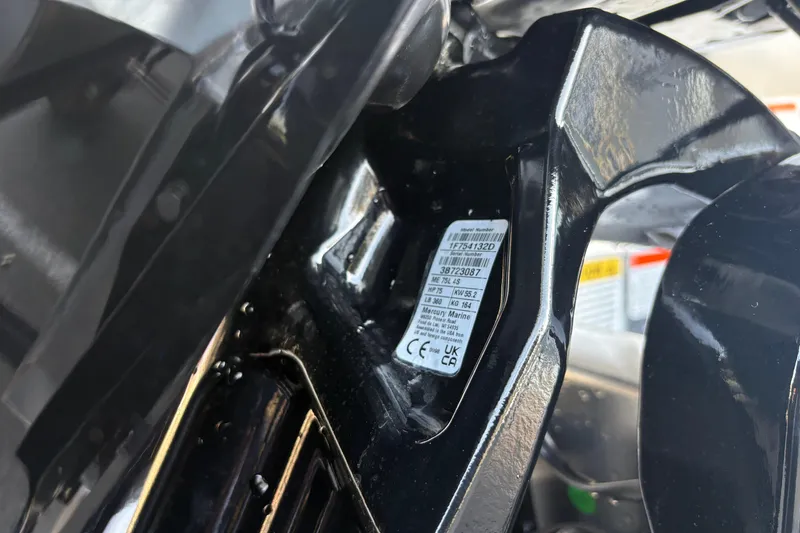 Slide: The Image of Close-up of a 2026 Sun Tracker Bass Buggy 18 DLX engine label. - 28