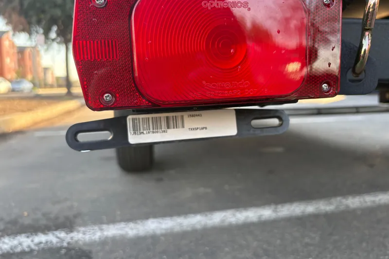 Slide: The Image of Close-up of a 2026 Sun Tracker Bass Buggy 18 DLX trailer tail light. - 31