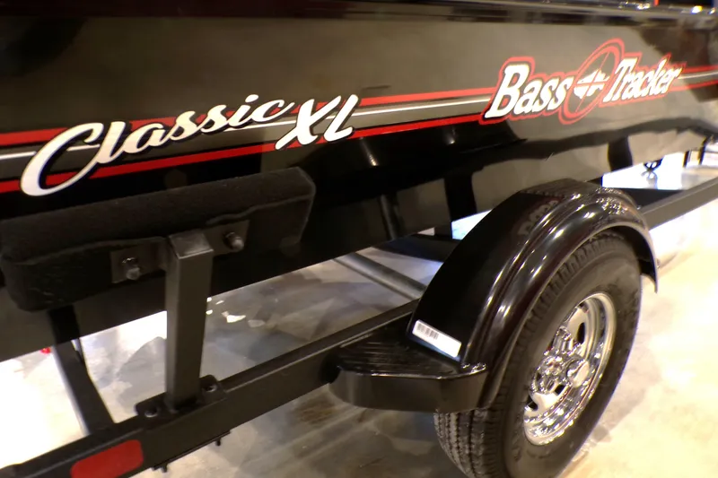 Slide: The Image of 2026 Tracker Bass Tracker Classic XL boat on trailer, parked outside a building. - 62
