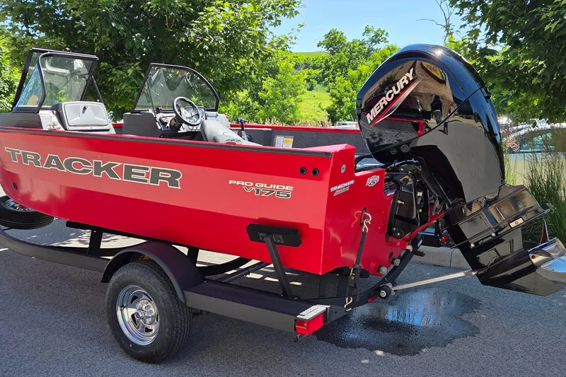 The Image of 2026 Tracker Pro Guide V-175 Combo boat with Mercury engine, parked outdoors. - 0