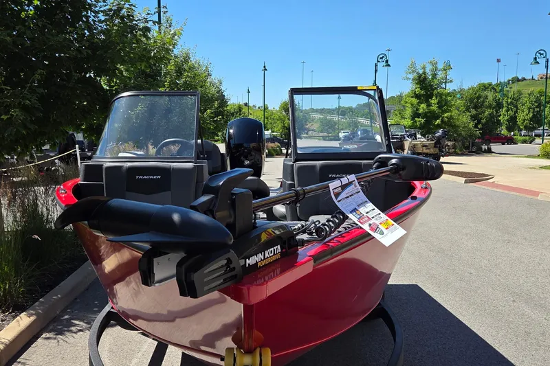 Slide: The Image of 2026 Tracker Pro Guide V-175 Combo boat with Minn Kota motor, parked outdoors. - 2