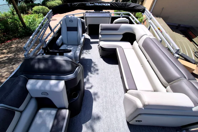 Slide: The Image of 2026 Sun Tracker Fishin' Barge 22 DLX interior with spacious seating and modern design. - 13