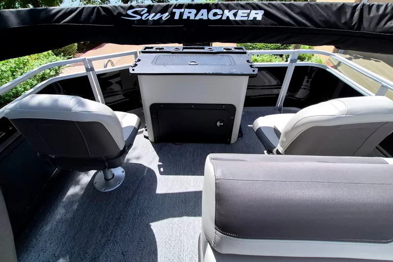 Slide: The Image of 2026 Sun Tracker Fishin' Barge 22 DLX interior with seating and console. - 14