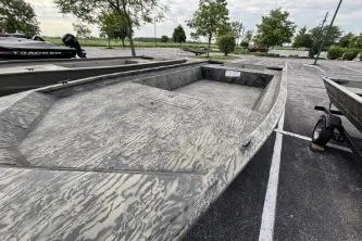 Slide: The Image of 2026 Tracker Grizzly 1860 Utility boat in parking lot, showcasing rugged design. - 9