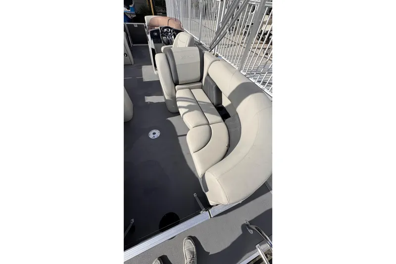 Slide: The Image of 2024 Sylvan 822 LZ boat interior with beige seating and modern design. - 25