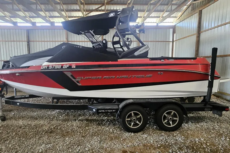 The Image of 2016 Nautique Super Air Nautique 210 boat in a storage facility. - 1