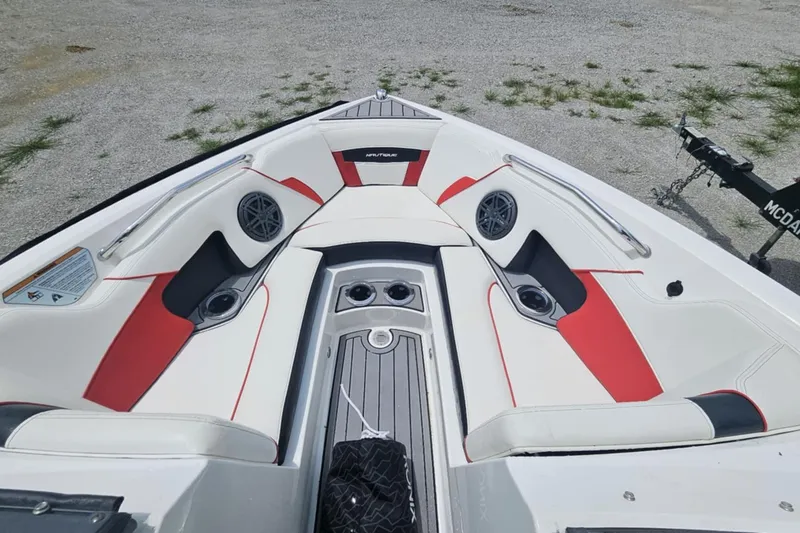 Slide: The Image of 2016 Nautique Super Air Nautique 210 boat interior with red and white seating. - 4