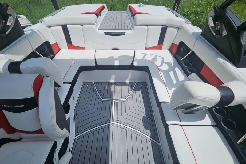Slide: The Image of 2016 Nautique Super Air Nautique 210 interior with white, red, and black seating. - 5