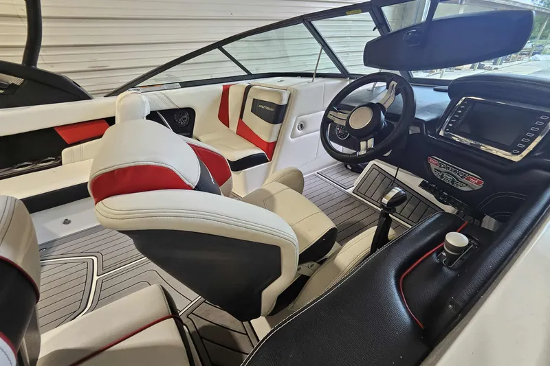 Slide: The Image of 2016 Nautique Super Air Nautique 210 interior with modern dashboard and seating. - 6