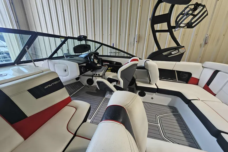Slide: The Image of 2016 Nautique Super Air Nautique 210 interior with sleek seating and modern dashboard. - 8