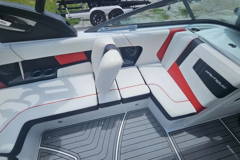 Slide: The Image of 2016 Nautique Super Air Nautique 210 interior with white, red, and black seating. - 9