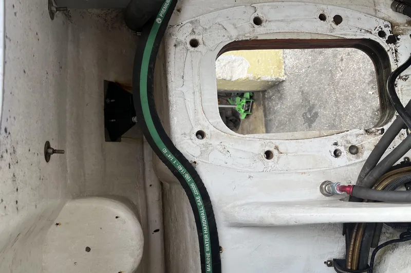 Slide: The Image of 2007 Nor-Tech Supercat 3600 interior with compact bathroom and storage area. - 16