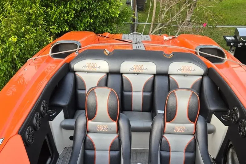 Slide: The Image of 2009 Nor-Tech Supercat 3600 interior with orange and black seating, surrounded by lush greenery. - 19
