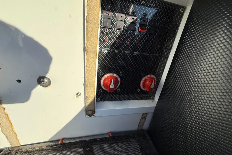 Slide: The Image of Control panel of a 2007 Nor-Tech Supercat 3600 boat with switches and dials. - 25