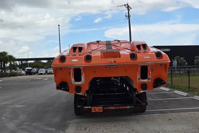 Slide: The Image of 2009 Nor-Tech Supercat 3600 in orange, rear view on trailer, parked outdoors. - 27