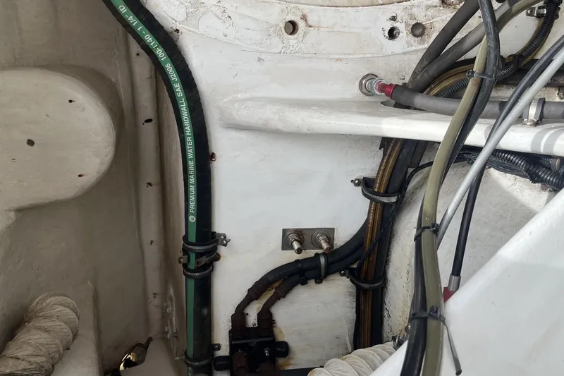Slide: The Image of 2007 Nor-Tech Supercat 3600 engine compartment with marine hoses and wiring. - 32