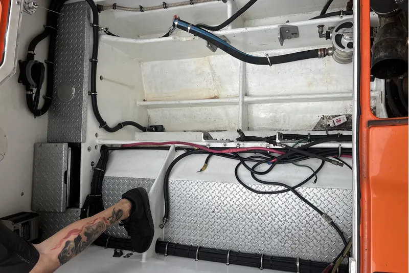 Slide: The Image of 2007 Nor-Tech Supercat 3600 engine compartment with wiring and diamond plate flooring. - 34