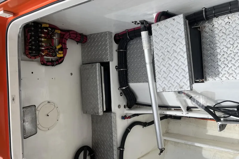 Slide: The Image of 2007 Nor-Tech Supercat 3600 engine compartment with wiring and diamond plate panels. - 35