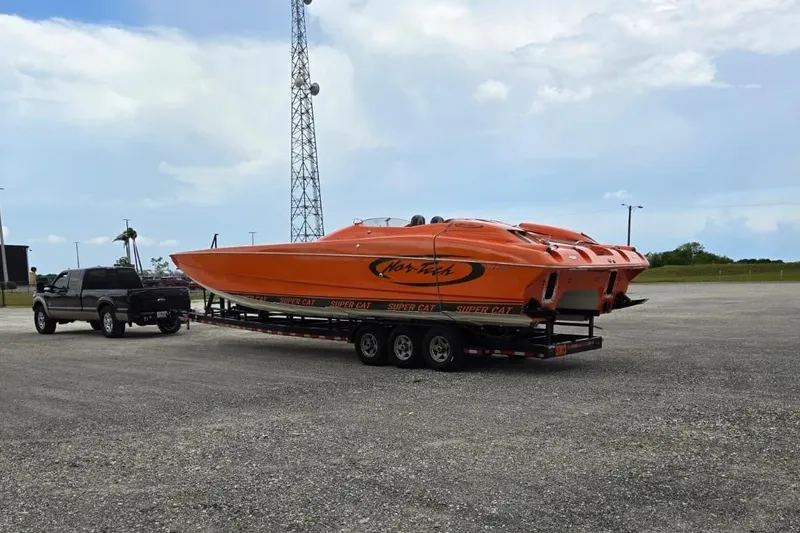Slide: The Image of 2009 Nor-Tech Supercat 3600 on trailer, bright orange, parked in open area. - 42
