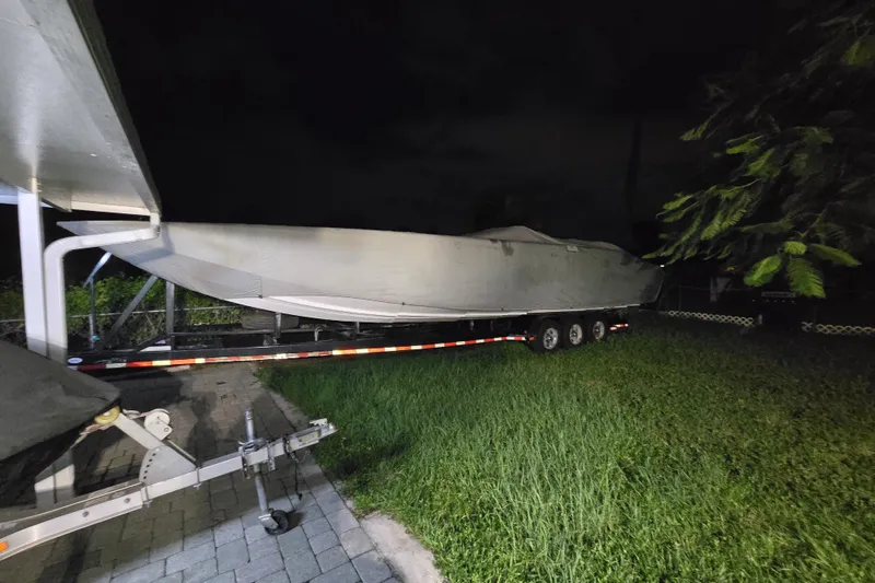 Slide: The Image of 2009 Nor-Tech Supercat 3600 boat on trailer at night, parked on grass. - 43