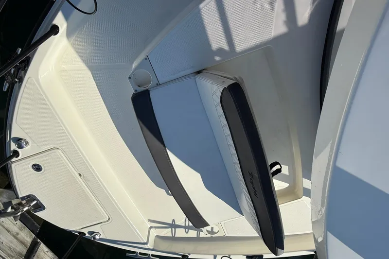 Slide: The Image of 2024 Bayliner Trophy T25 Pilothouse boat deck with seating and storage compartments. - 26
