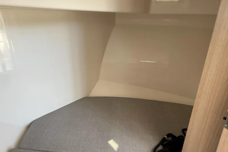 Slide: The Image of 2024 Bayliner Trophy T25 Pilothouse interior cabin with cushioned seating. - 35