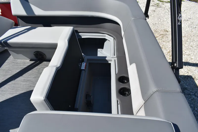 Slide: The Image of 2026 Lowe LS 190 boat interior with open storage compartment and cup holders. - 13
