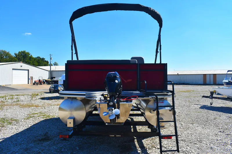 Slide: The Image of 2026 Lowe LS 190 pontoon boat with outboard motor in a sunny outdoor setting. - 3