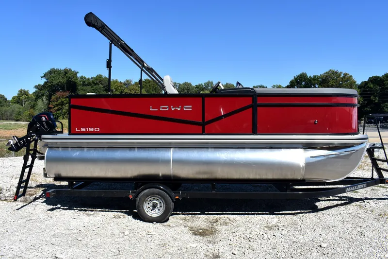Slide: The Image of 2026 Lowe LS 190 pontoon boat on trailer, red and silver design, outdoor setting. - 4