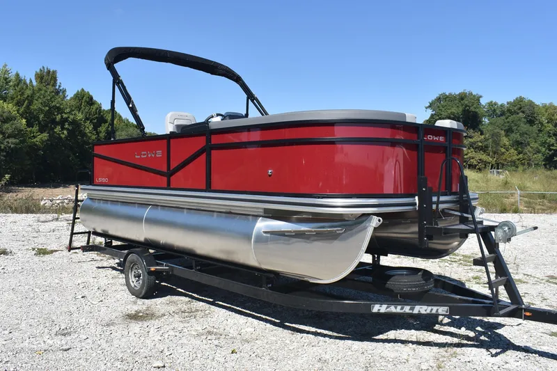Slide: The Image of 2026 Lowe LS 190 pontoon boat on trailer, red and silver design, outdoor setting. - 5