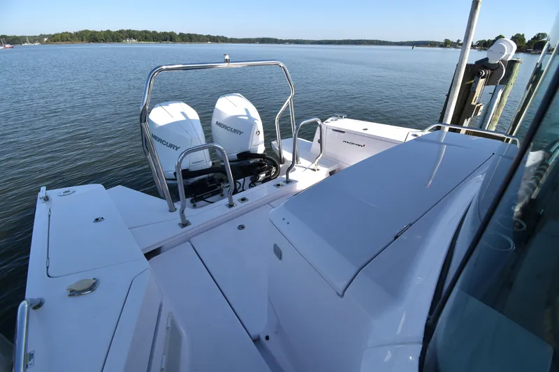 Slide: The Image of 2023 Axopar 37XC Wet Bar with dual Mercury engines on a serene lake. - 13