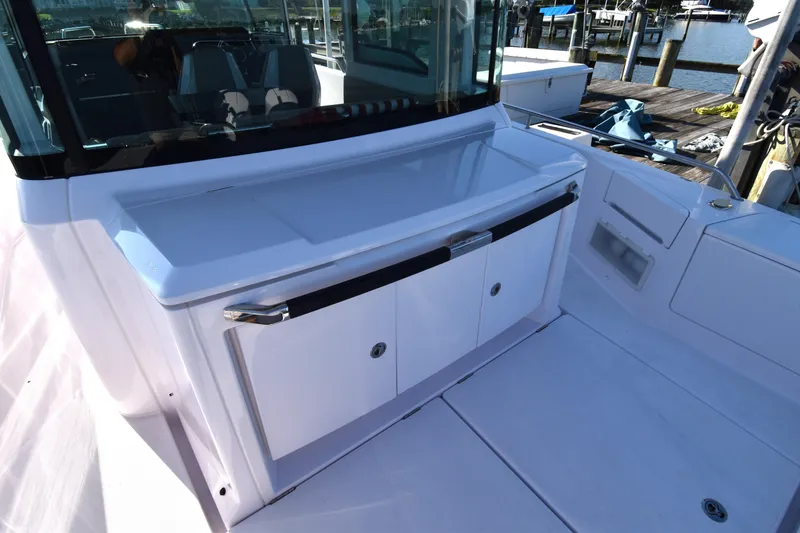 Slide: The Image of 2023 Axopar 37XC Wet Bar, sleek design, docked at marina. - 14