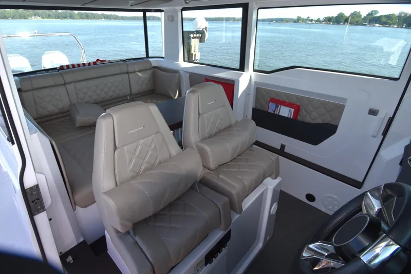 Slide: The Image of 2023 Axopar 37XC Wet Bar interior with luxurious seating and panoramic windows. - 18