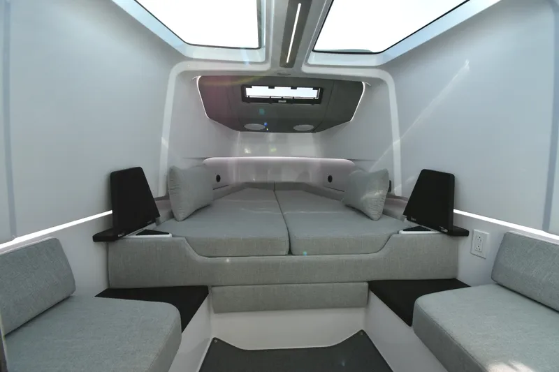 Slide: The Image of 2023 Axopar 37XC Wet Bar interior cabin with modern seating and skylight. - 22