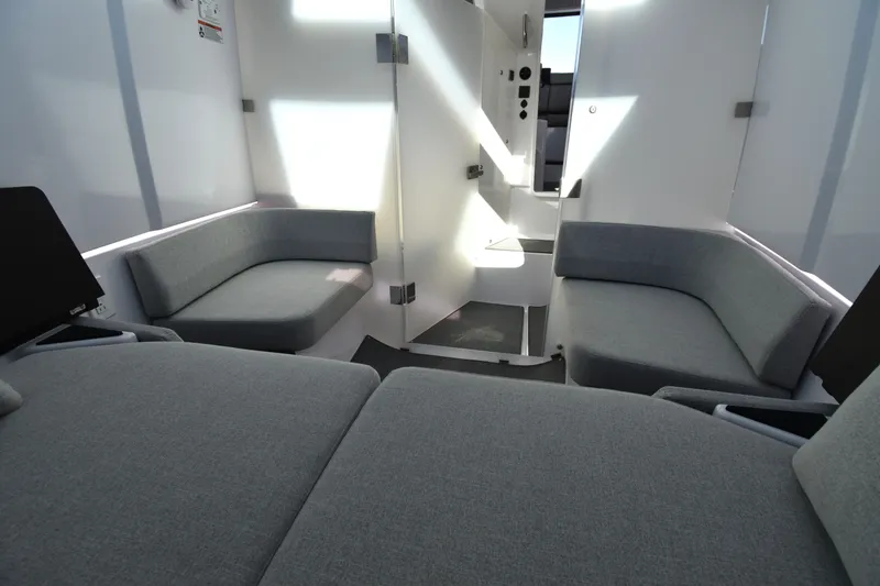 Slide: The Image of 2023 Axopar 37XC Wet Bar interior with modern gray seating and sleek design. - 23