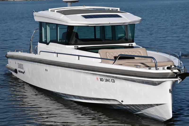 Slide: The Image of 2023 Axopar 37XC Wet Bar boat on calm water, featuring sleek design and modern amenities. - 3