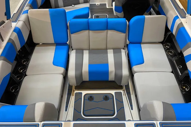 Slide: The Image of 2024 Malibu Wakesetter 23 MXZ interior with blue and gray seating arrangement. - 11