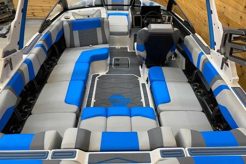 Slide: The Image of 2024 Malibu Wakesetter 23 MXZ interior with blue and gray seating, modern design. - 5